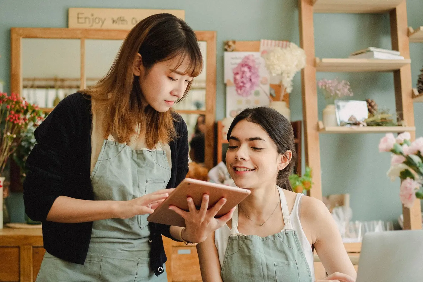 Two shop owners checking their new system together on a tablet